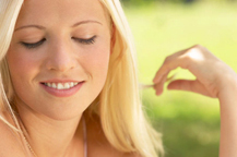 Blonde woman smiling in a sexy manner